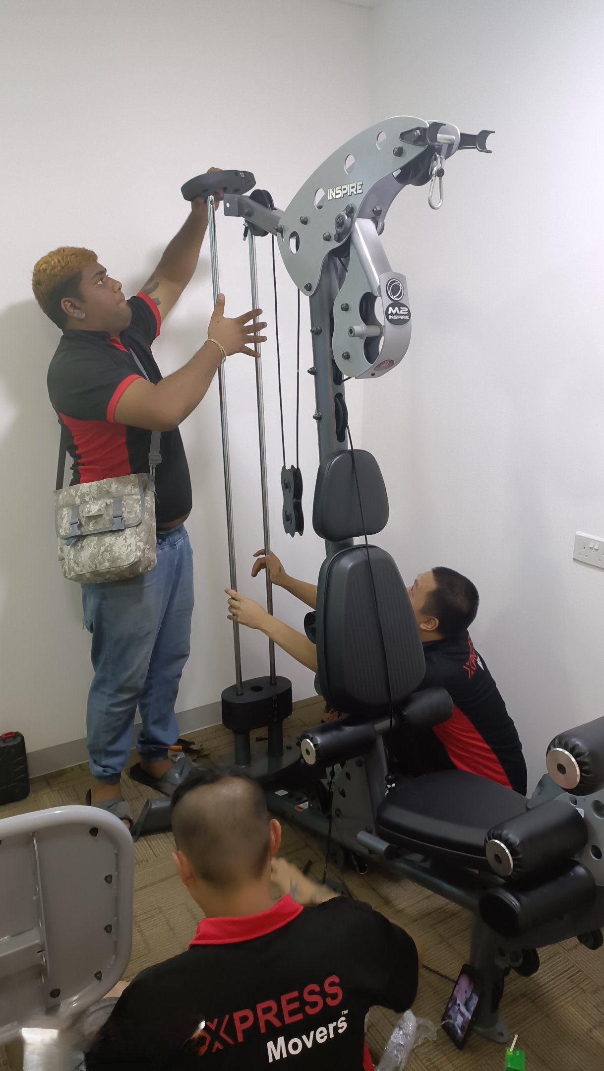 Oplus_0 movers dismantling gym equipment